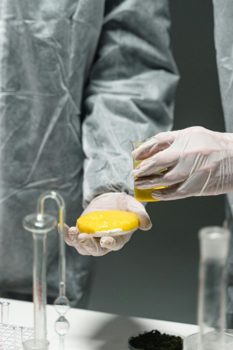 Close-up of scientists in a lab testing substances using advanced laboratory equipment.